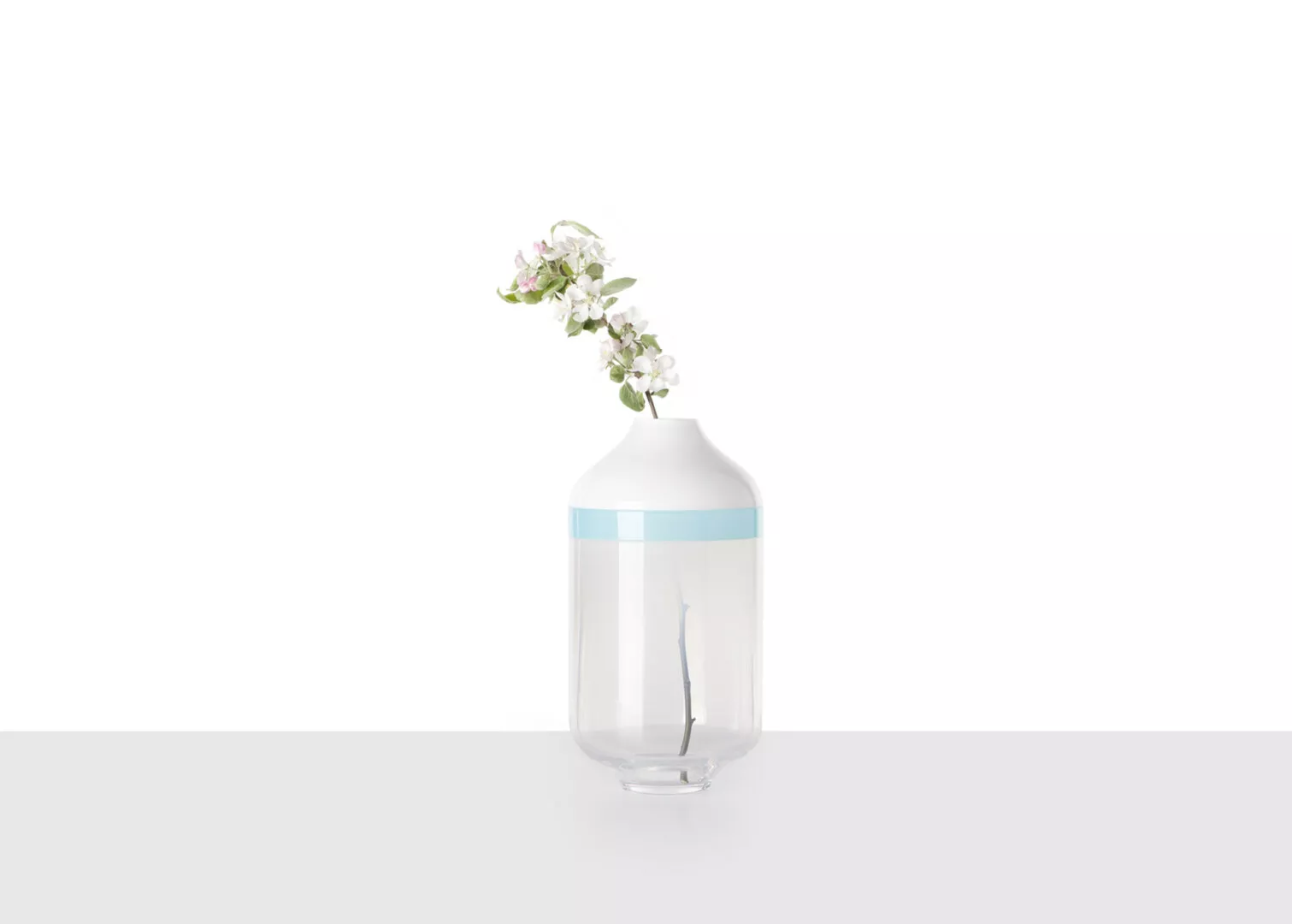 Minimalist vase with single blooming branch.