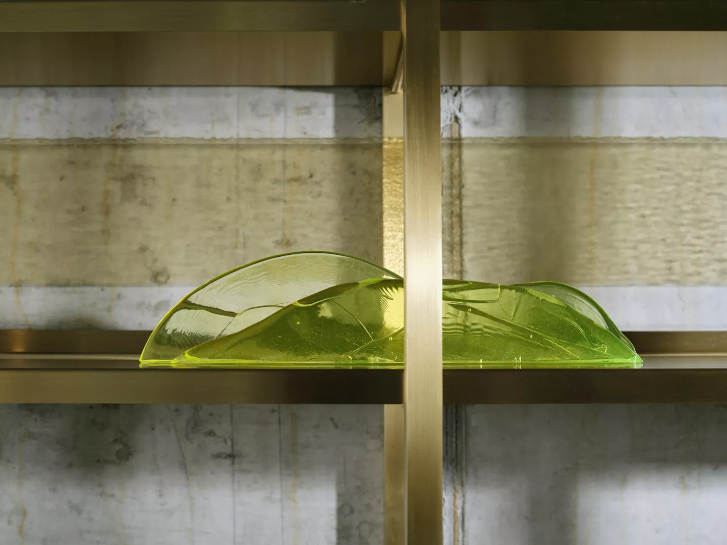 Green glass decorative plates on marble shelf.