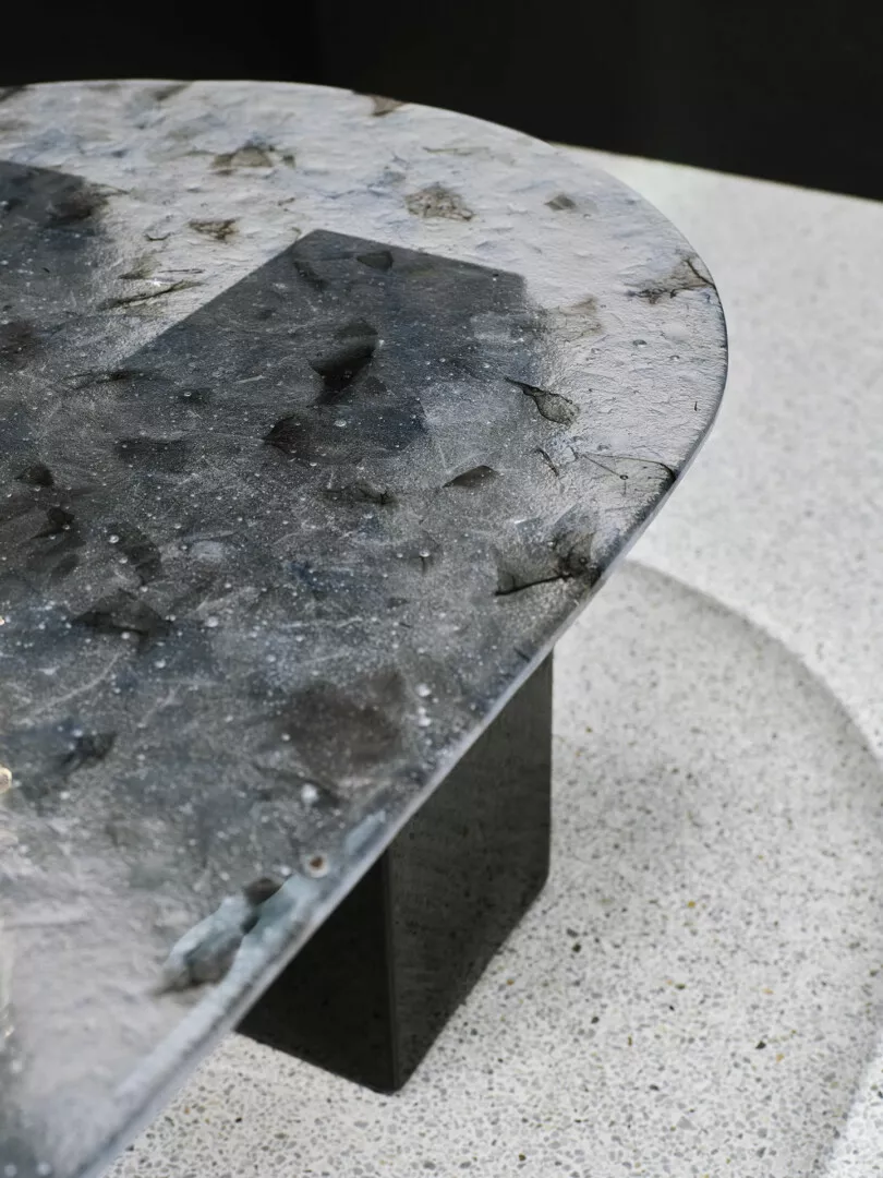 Terrazzo table on contrasting speckled floor.