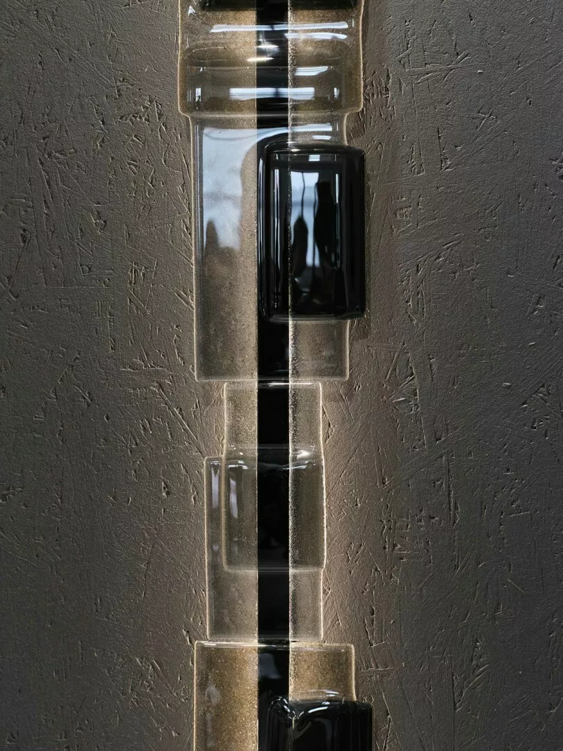 Glass blocks embedded in textured concrete wall, artistic lighting.