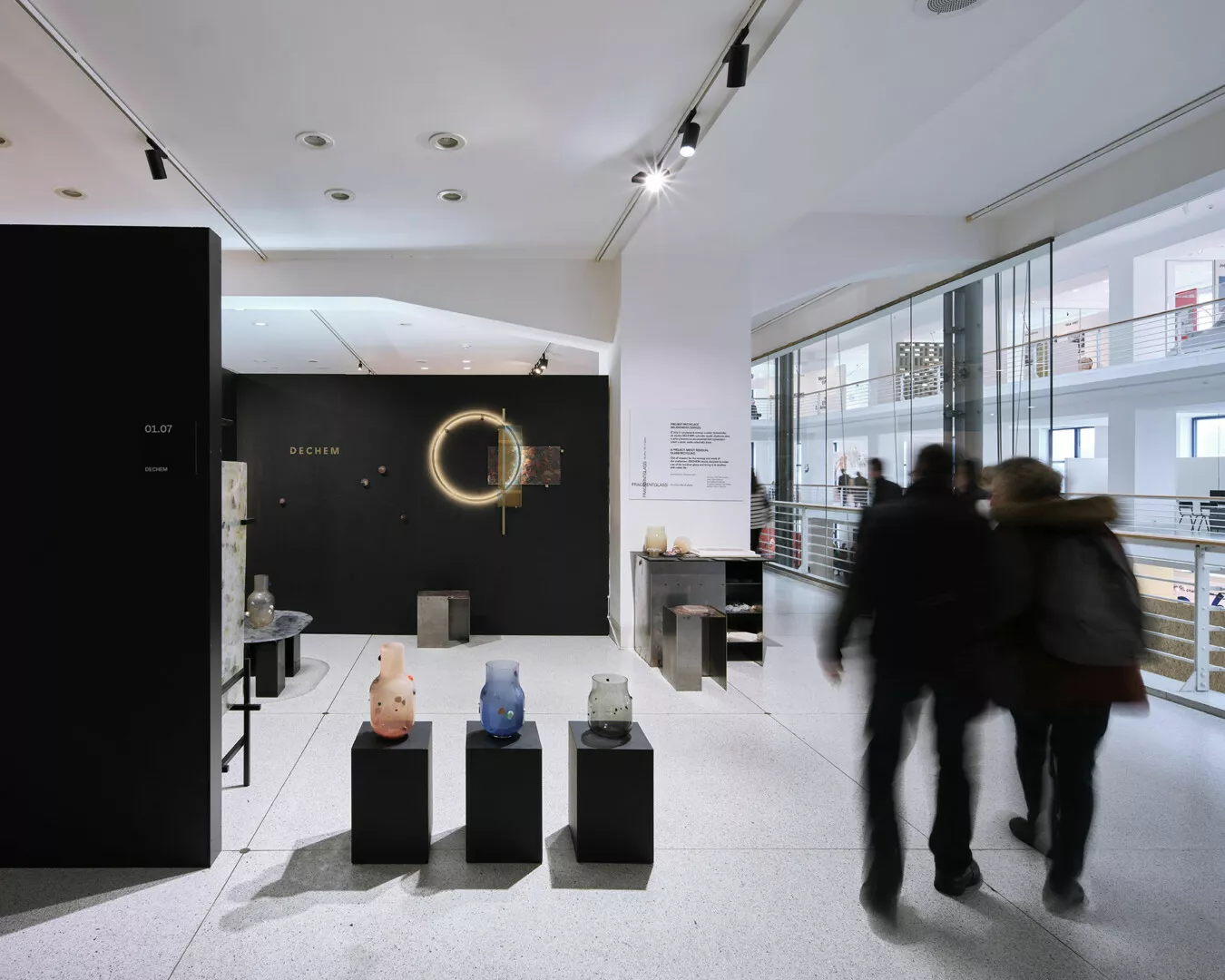 Visitors exploring modern art exhibit in gallery.