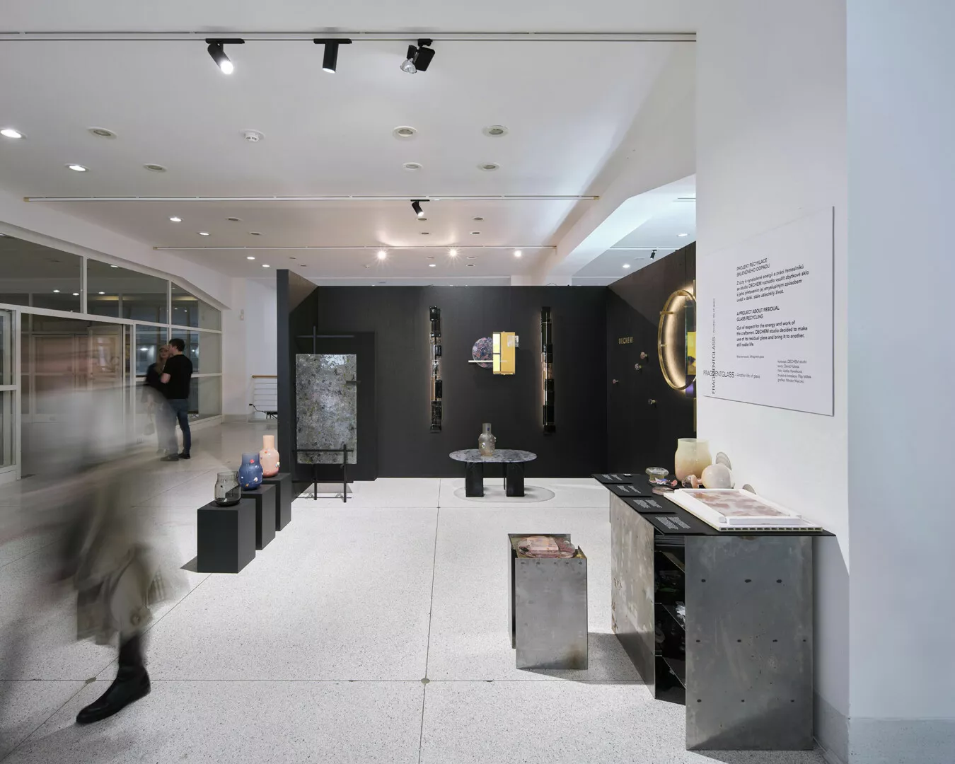 Modern art exhibit with visitors and interactive displays.