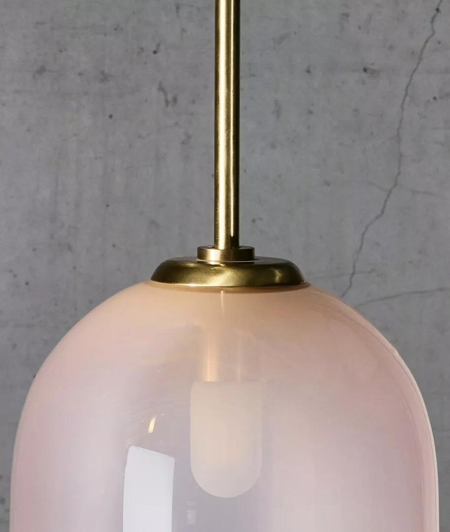 Pink glass pendant light with gold accents.