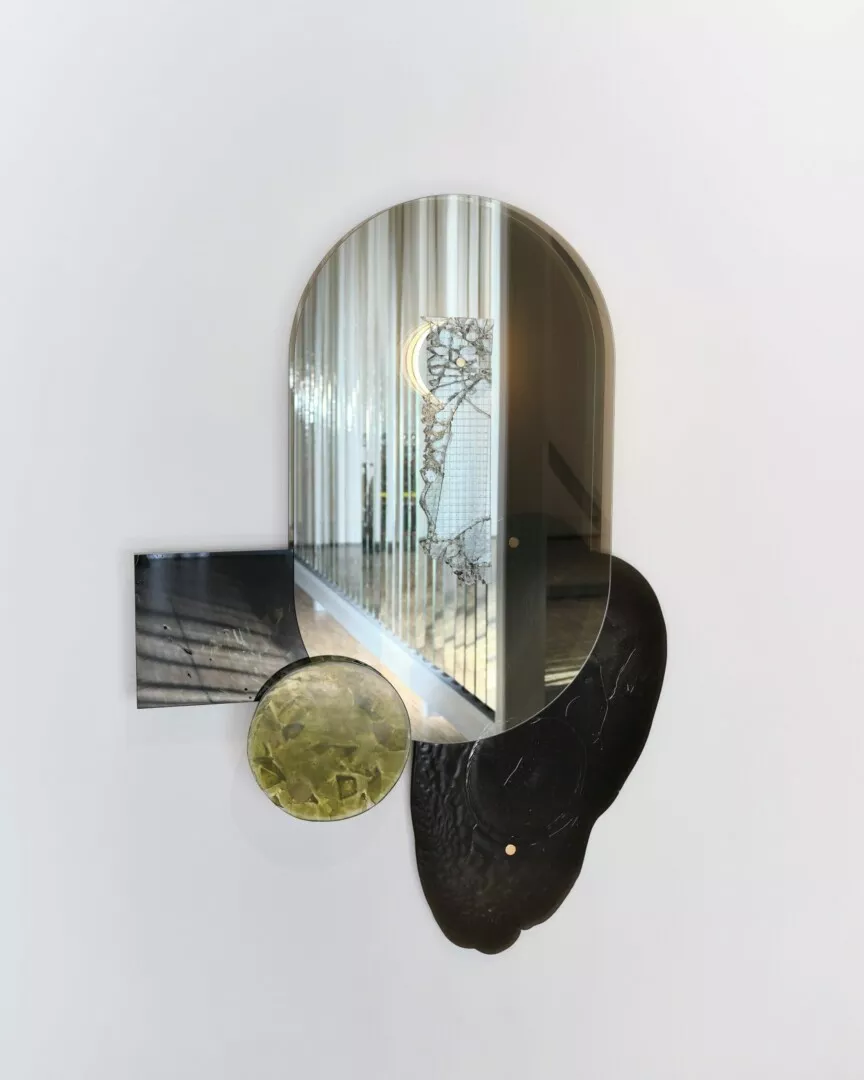 Abstract sculptural wall art with mixed materials and textures.