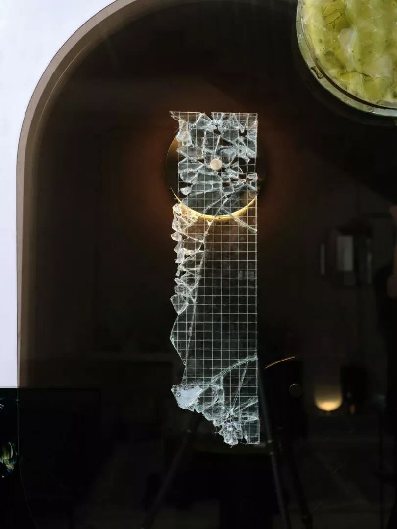 Abstract glass sculpture displayed in window.