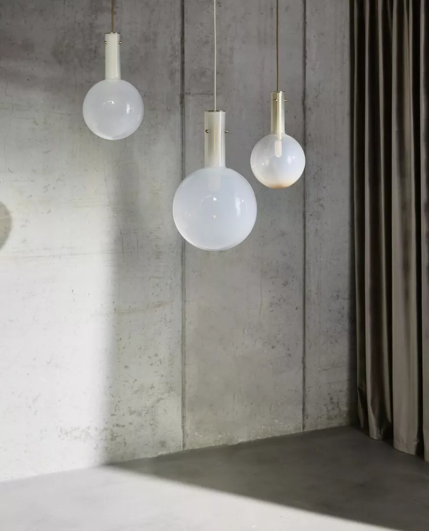 Three hanging globe pendant lights in a modern setting.