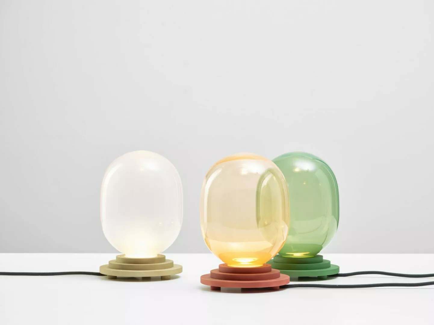 Three colorful modern spherical table lamps.