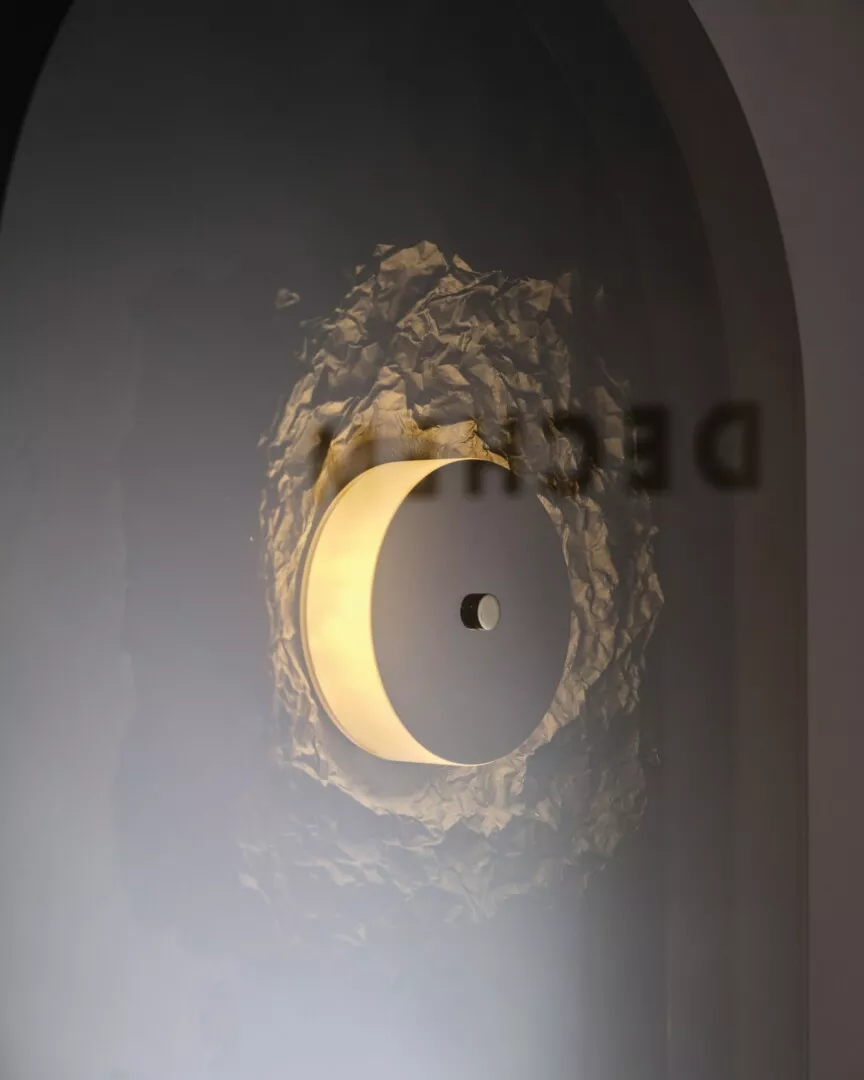 Modern wall light fixture with textured design.