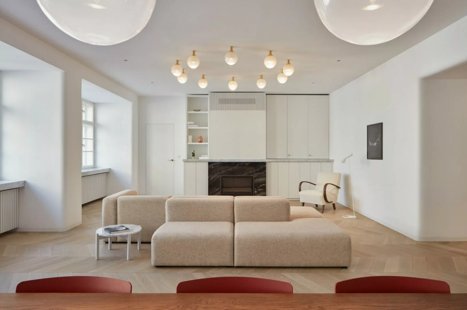 Modern minimalist living room with fireplace and stylish lighting.